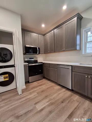 a kitchen with stainless steel appliances a refrigerator and stove