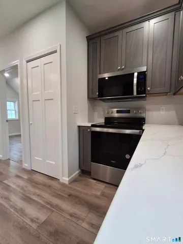 a view of a kitchen with a sink and a refrigerator