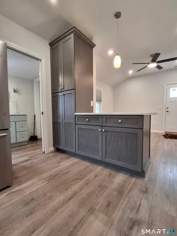 a kitchen with stainless steel appliances granite countertop a refrigerator a sink a stove a microwave and island