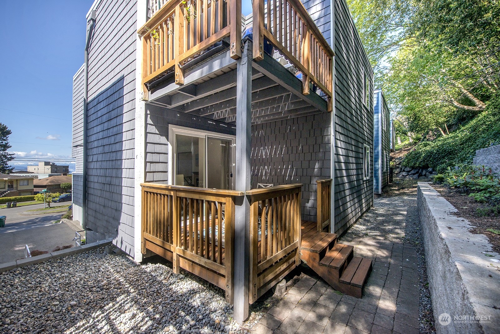 4118 58th Place Southwest, Unit 2 Seattle, WA 98116 - Photo 19 of 23 a view of a small house with wooden floor fence and a porch