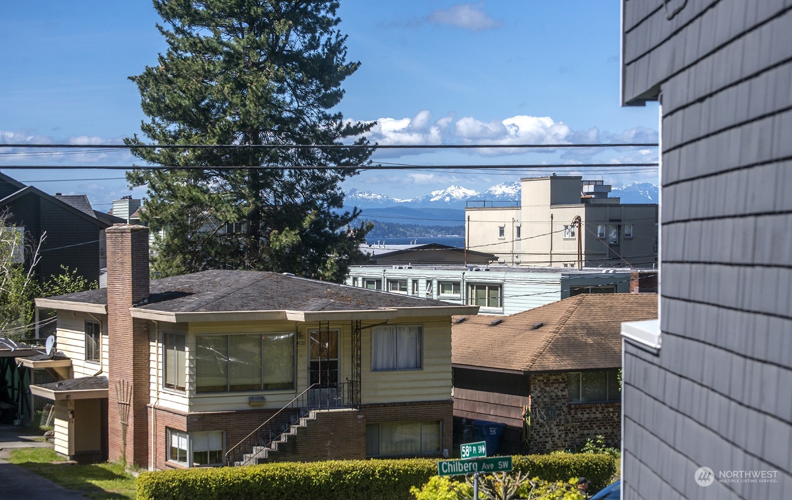 4118 58th Place Southwest, Unit 2 Seattle, WA 98116 - Photo 22 of 23 a front view of a house with a yard