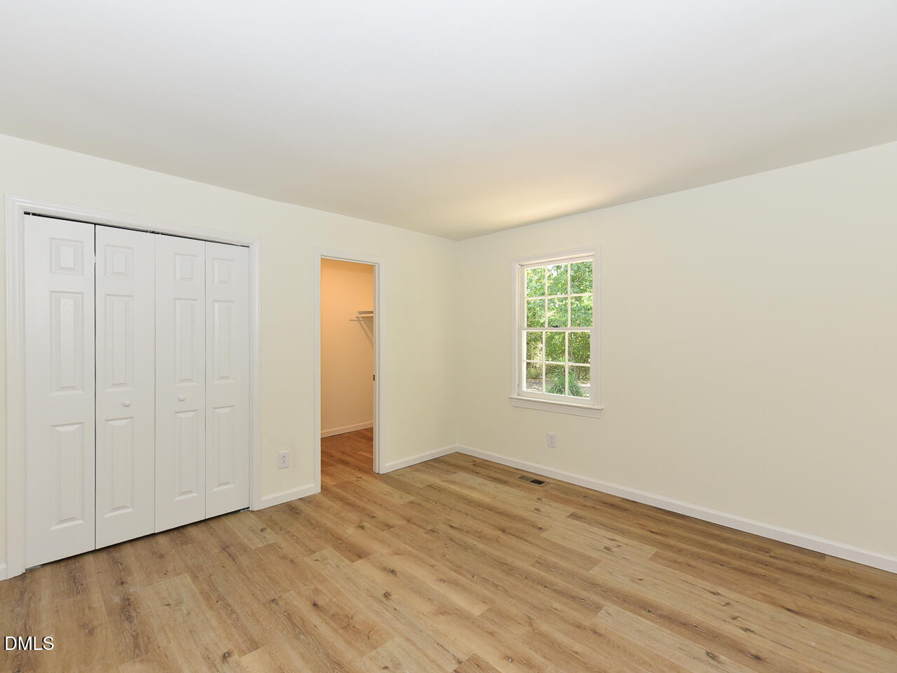 939 Cheves Road Zebulon, NC 27597 - Photo 11 of 21 an empty room with wooden floor and windows