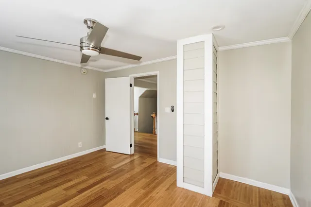 a view of empty room with wooden floor