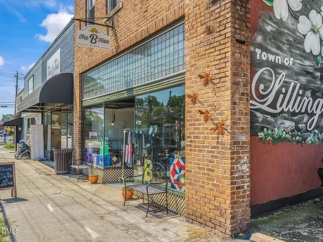 a view of a brick house with a street sign on the wall
