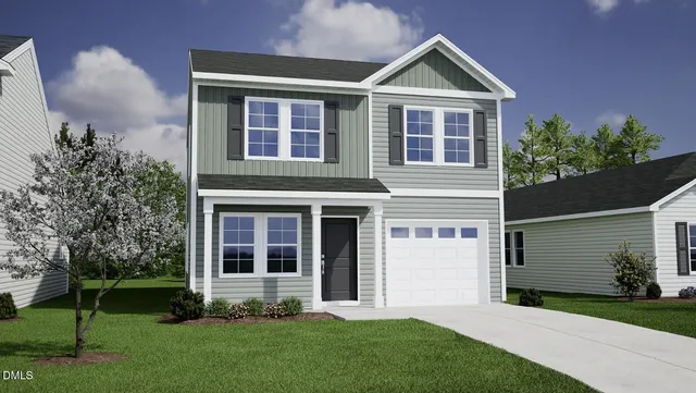 a front view of a house with a yard and garage