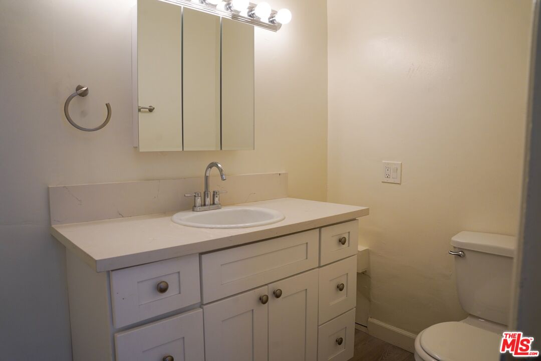 18444 Collins Street, Unit 14 Tarzana, CA 91356 - Photo 12 of 18 a bathroom with a toilet sink and mirror