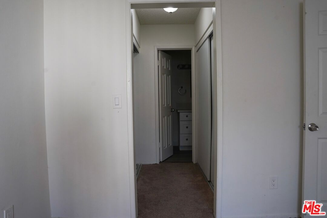 18444 Collins Street, Unit 14 Tarzana, CA 91356 - Photo 14 of 18 a view of a hallway with closet
