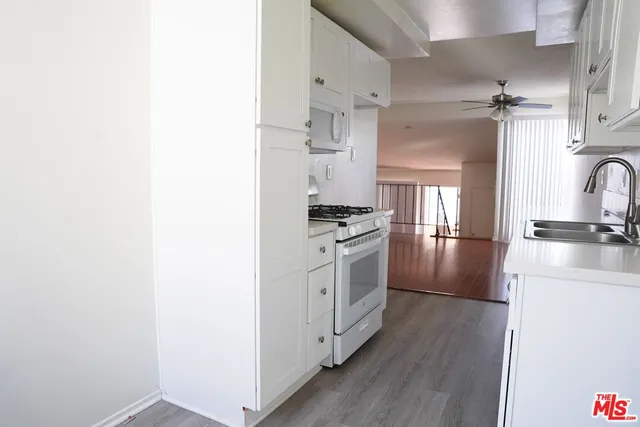 a kitchen with stainless steel appliances a refrigerator and a stove top oven