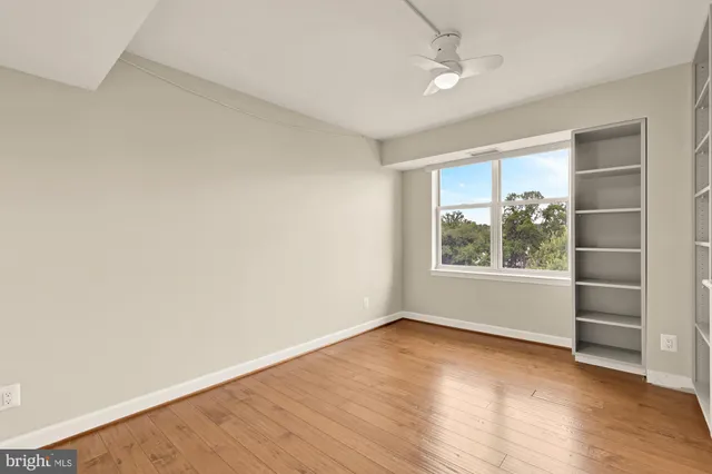 a bathroom with a toilet sink vanity and mirror