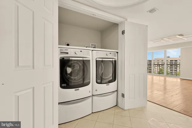 a living room with furniture large window and wooden floor