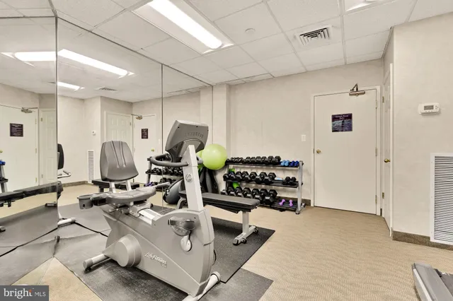 a kitchen with stainless steel appliances granite countertop white cabinets and a sink