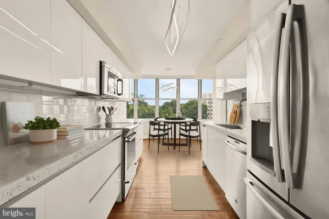 a dining room with furniture a chandelier and wooden floor