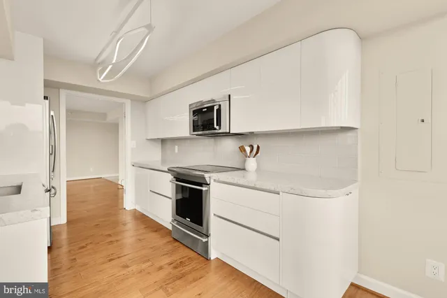 a view of a kitchen with a sink and refrigerator