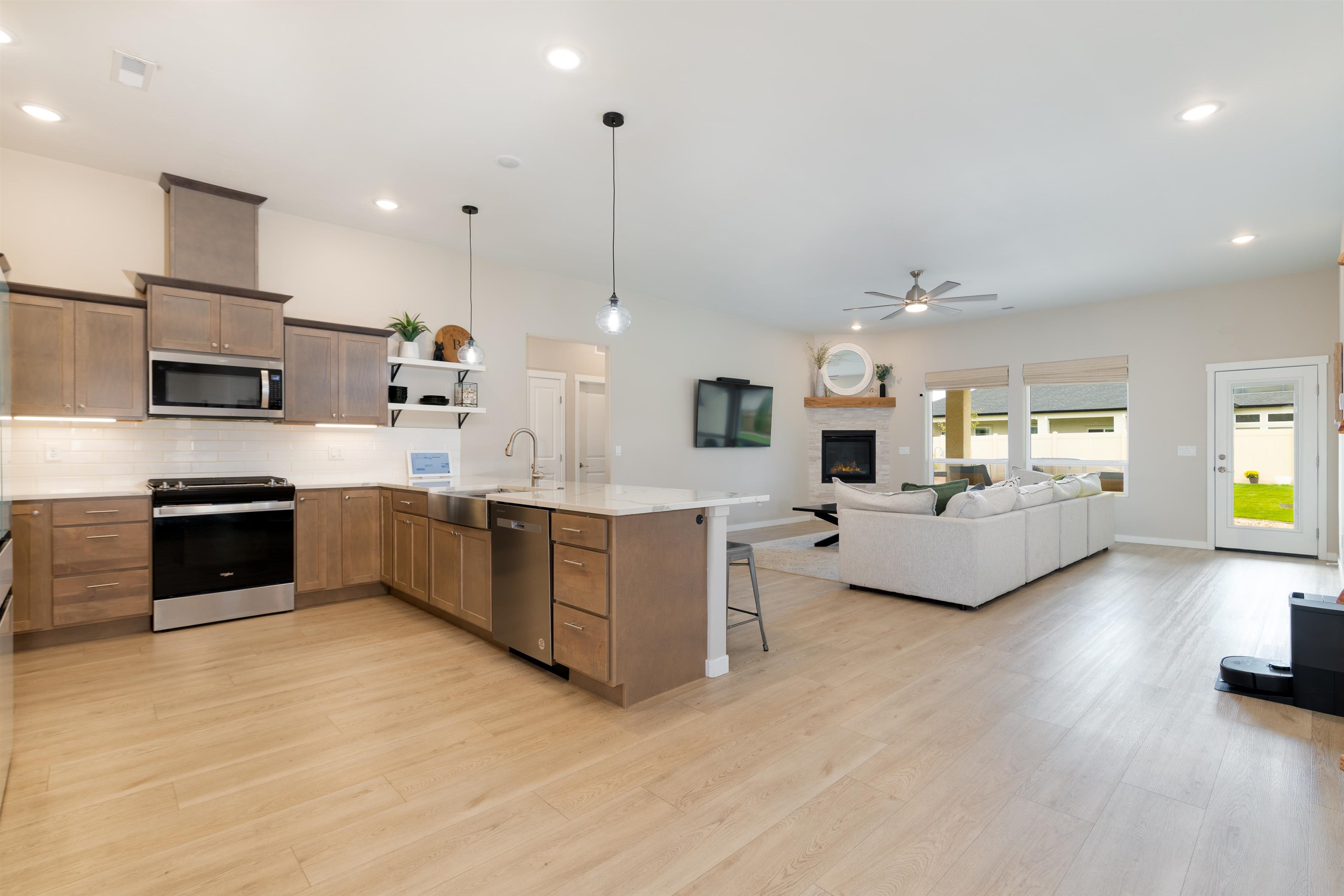 1518 Myers Lane Fruita, CO 81521 - Photo 7 of 39 a large white kitchen with stainless steel appliances kitchen island granite countertop a sink counter space and cabinets