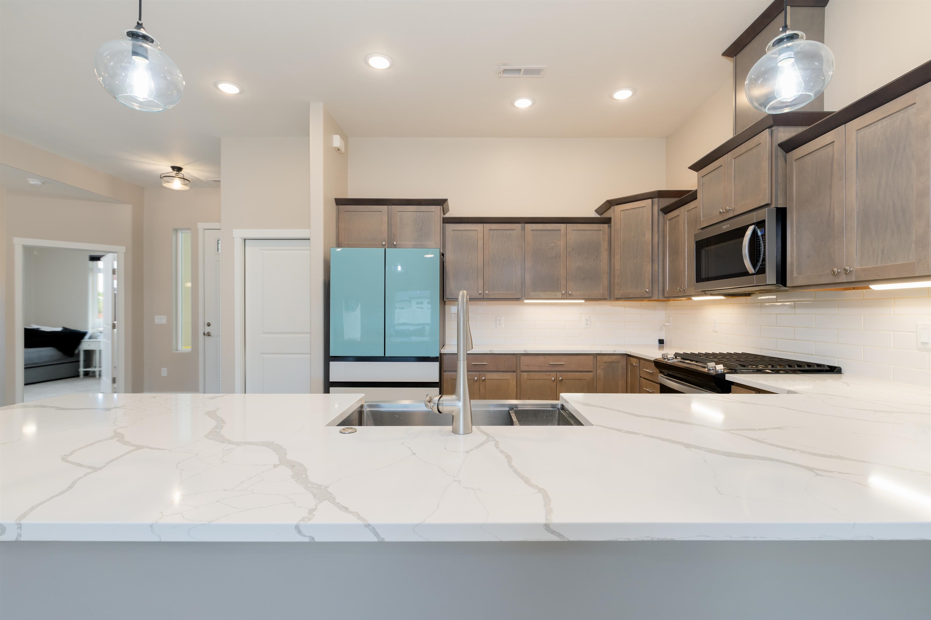 1518 Myers Lane Fruita, CO 81521 - Photo 10 of 39 a kitchen with stainless steel appliances kitchen island granite countertop a refrigerator and a sink