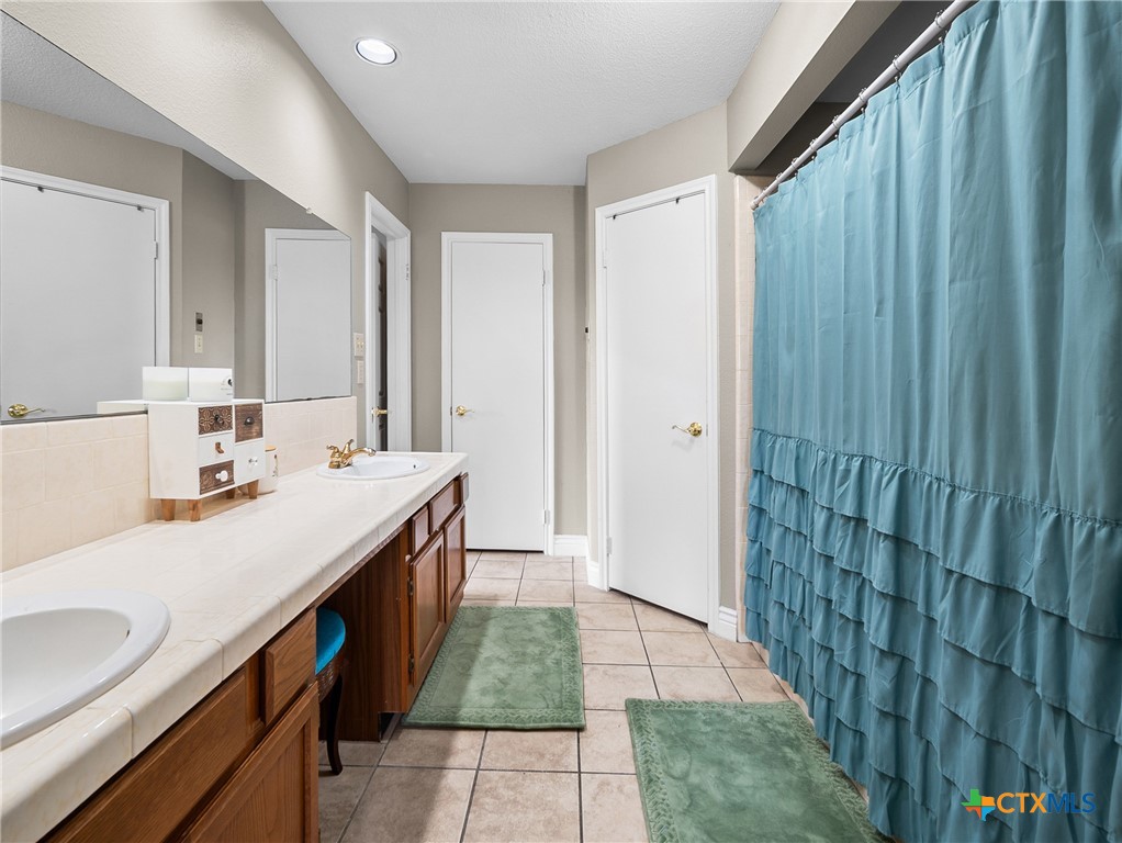 782 Santa Clara Loop Marion, TX 78124 - Photo 42 of 48 a bathroom with a sink and a mirror