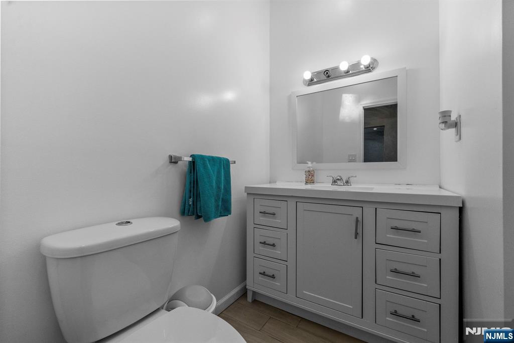 193 Fort Lee Road Teaneck, NJ 07666 - Photo 5 of 13 a bathroom with a toilet sink and mirror