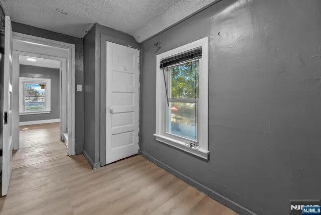 a bathroom with a granite countertop sink toilet a mirror a vanity and shower