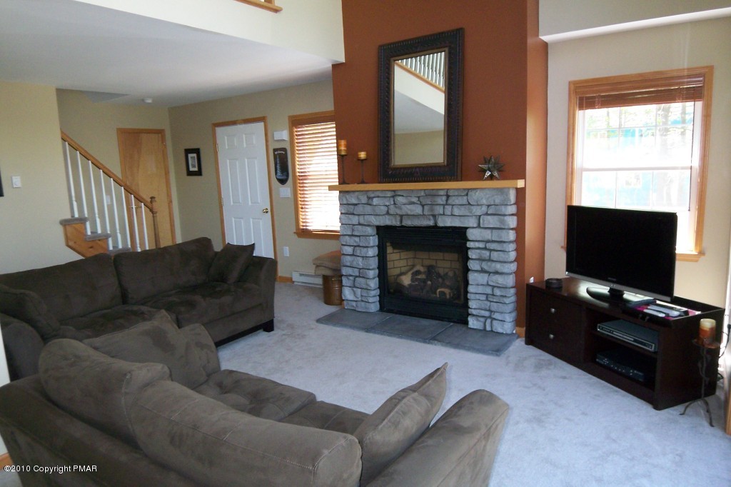 19 Brier Crest Road Blakeslee, PA 18610 - Photo 4 of 26 LIVING ROOM WITH STONE FIREPLACE
