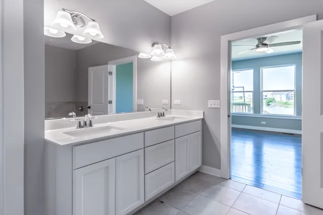 a bathroom with a double vanity sink and a mirror