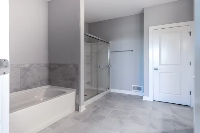 a bathroom with a bathtub and shower
