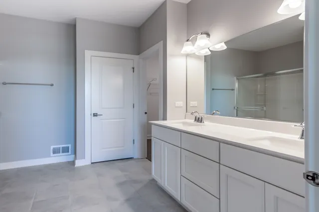 a bathroom with a double vanity sink and a bathtub