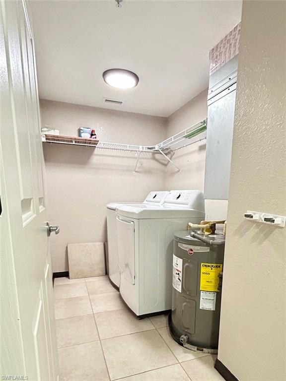 8284 Key Royal Circle, Unit 1323 Naples, FL 34119 - Photo 13 of 16 a utility room with washer and dryer