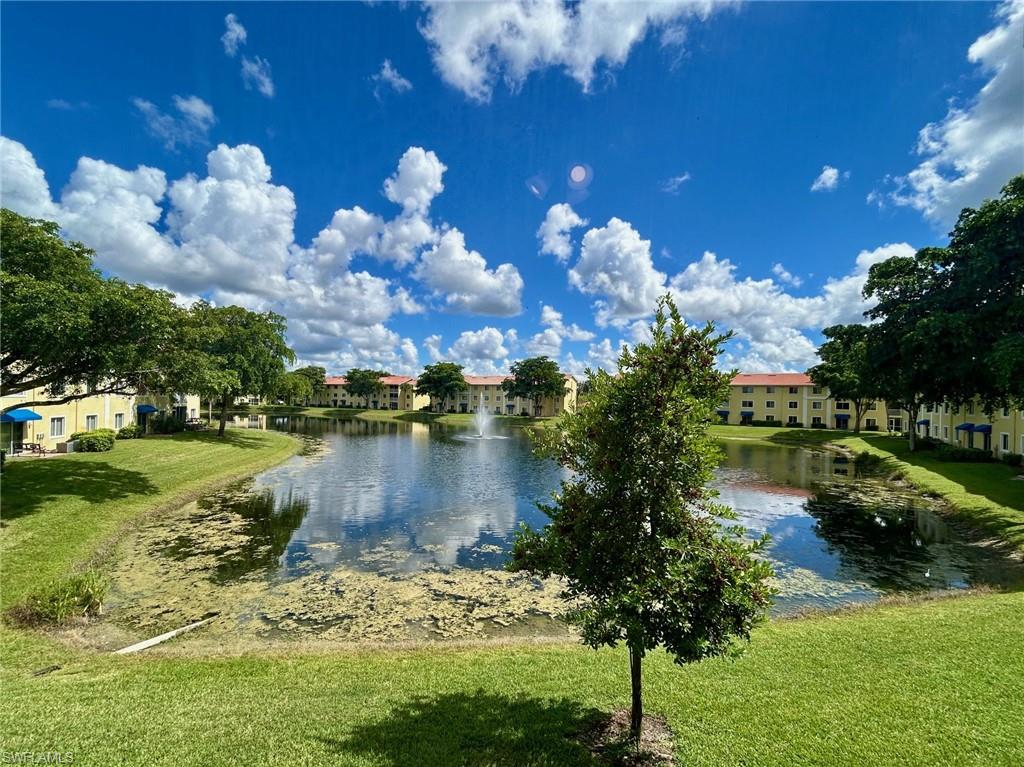 8284 Key Royal Circle, Unit 1323 Naples, FL 34119 - Photo 16 of 16 a view of a lake with a yard