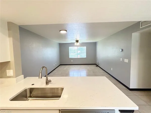 a view of a kitchen with a sink and a large window