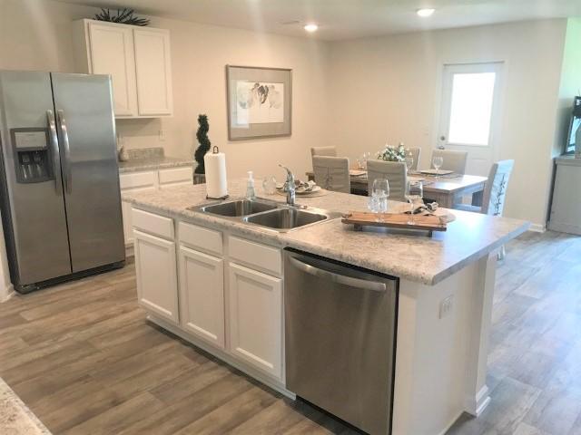 3476 Sparco Drive Crestview, FL 32539 - Photo 3 of 18 a kitchen with stainless steel appliances granite countertop a sink stove and refrigerator