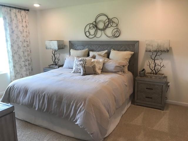 3476 Sparco Drive Crestview, FL 32539 - Photo 7 of 18 a bed sitting in a bedroom next to a bathroom