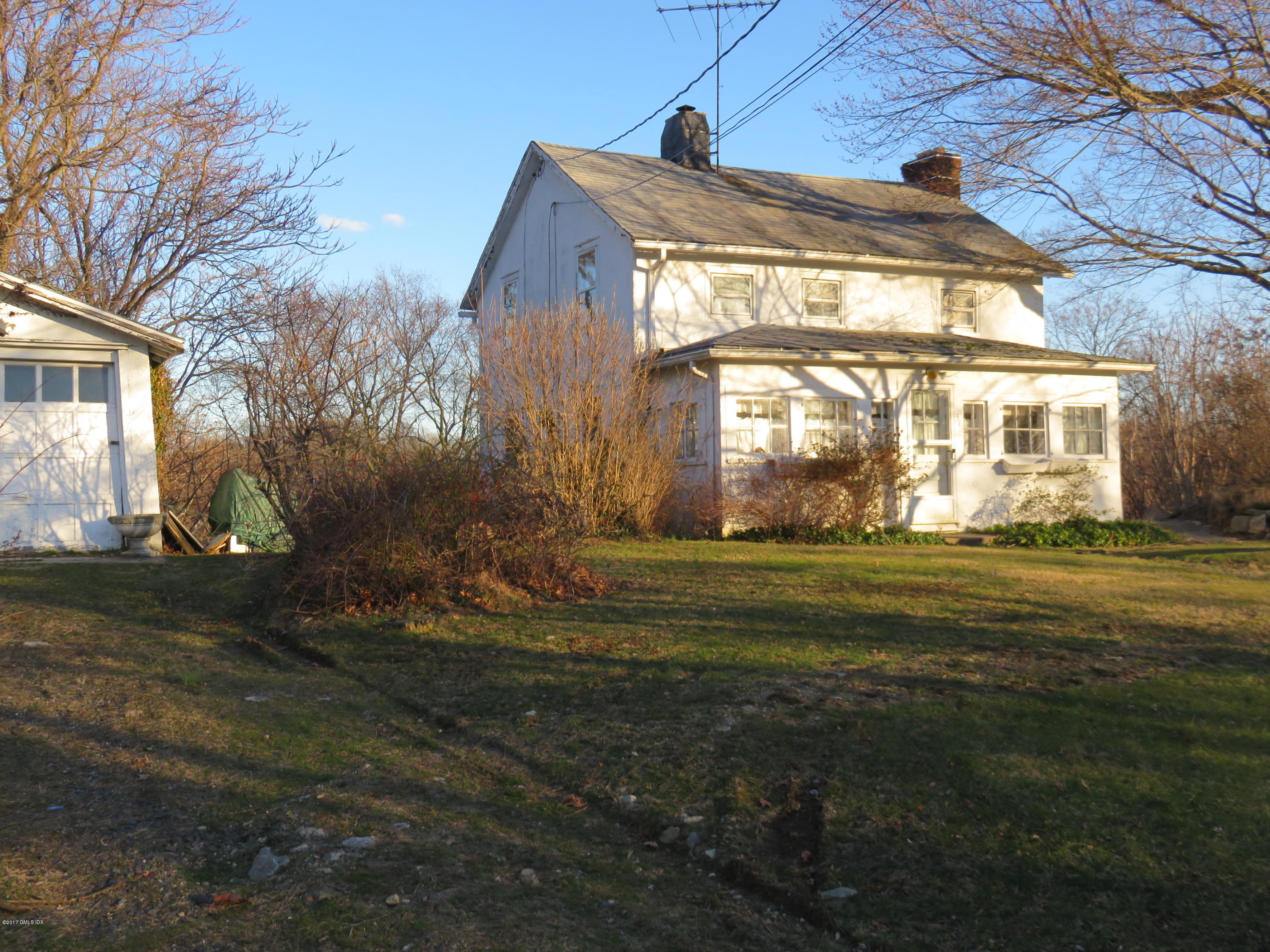 51 Sheep Hill Road Riverside, CT 06878 - Photo 3 of 5 a front view of a house with a yard