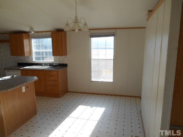 2329 Ward Store Road Fairmont, NC 28340 - Photo 8 of 12 a view of a kitchen with a sink cabinet and a window