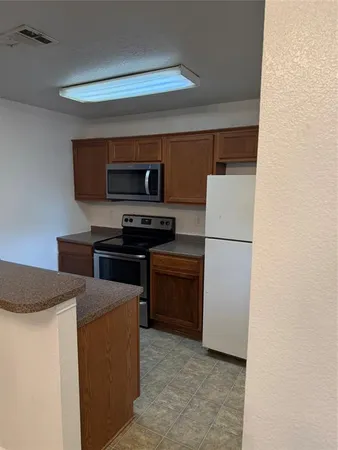 a kitchen with a refrigerator a stove and a sink