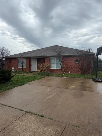 a front view of a house with a garden and yard