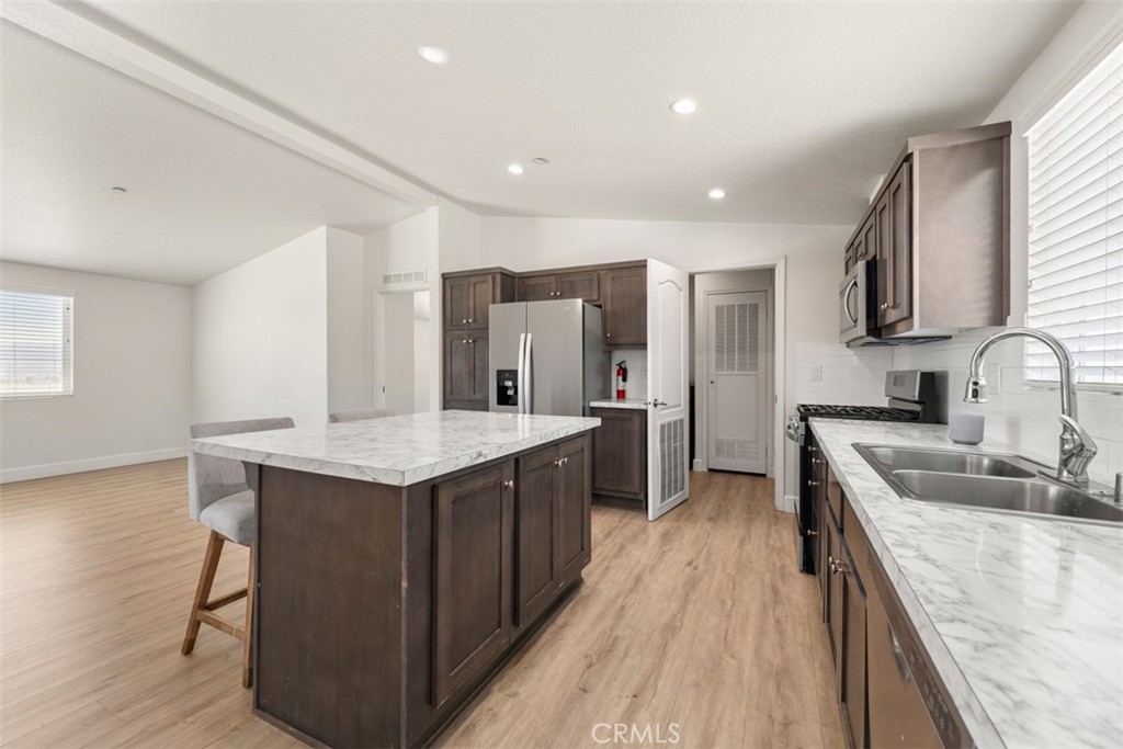 56040 Pena Road Anza, CA 92539 - Photo 10 of 42 a kitchen with stainless steel appliances granite countertop a sink stove and refrigerator