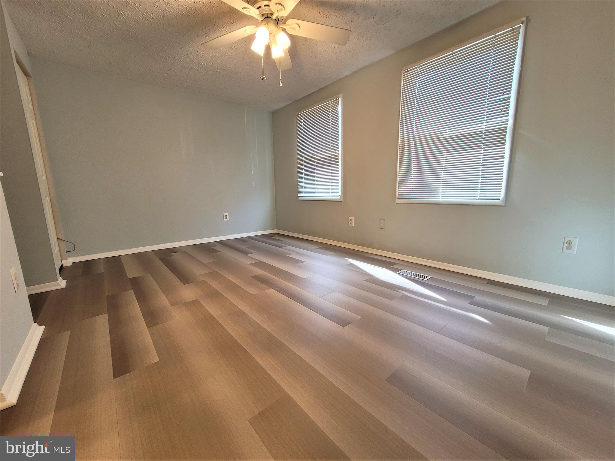 8072 Grandview Court Springfield, VA 22153 - Photo 15 of 32 a view of an empty room with wooden floor and a window