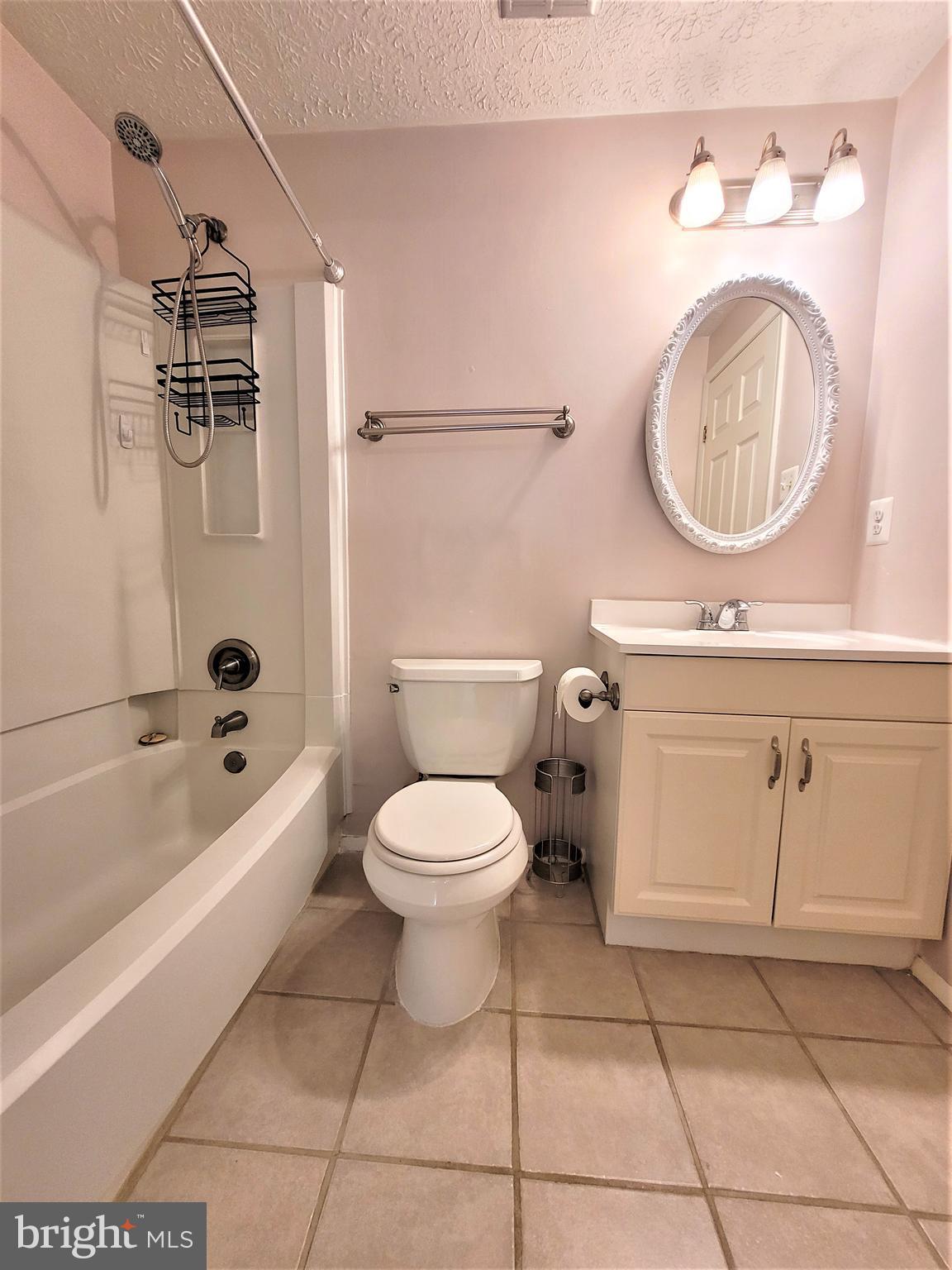 8072 Grandview Court Springfield, VA 22153 - Photo 17 of 32 a bathroom with a toilet sink vanity granite tub shower and mirror