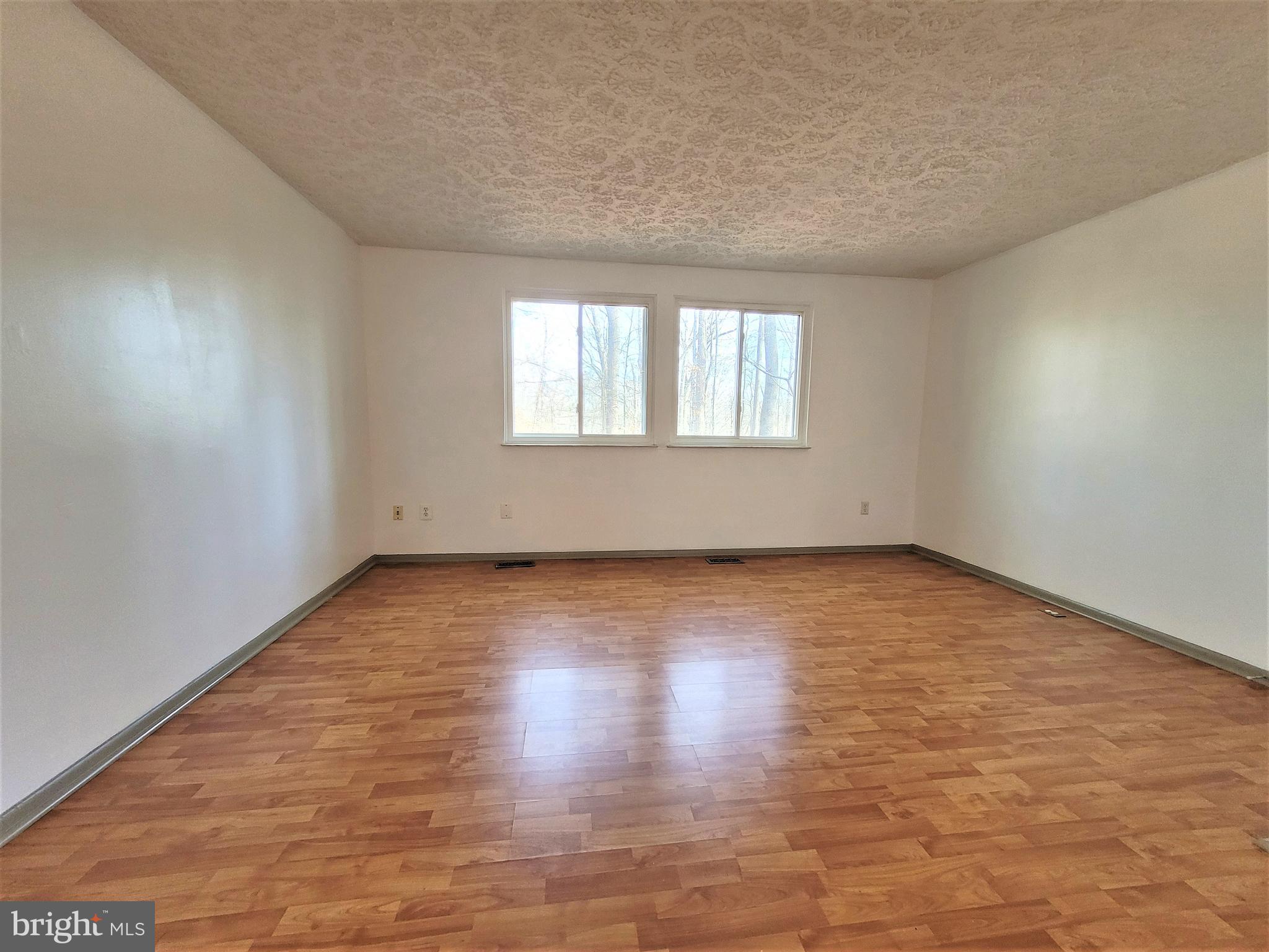 8072 Grandview Court Springfield, VA 22153 - Photo 6 of 32 an empty room with wooden floor and windows