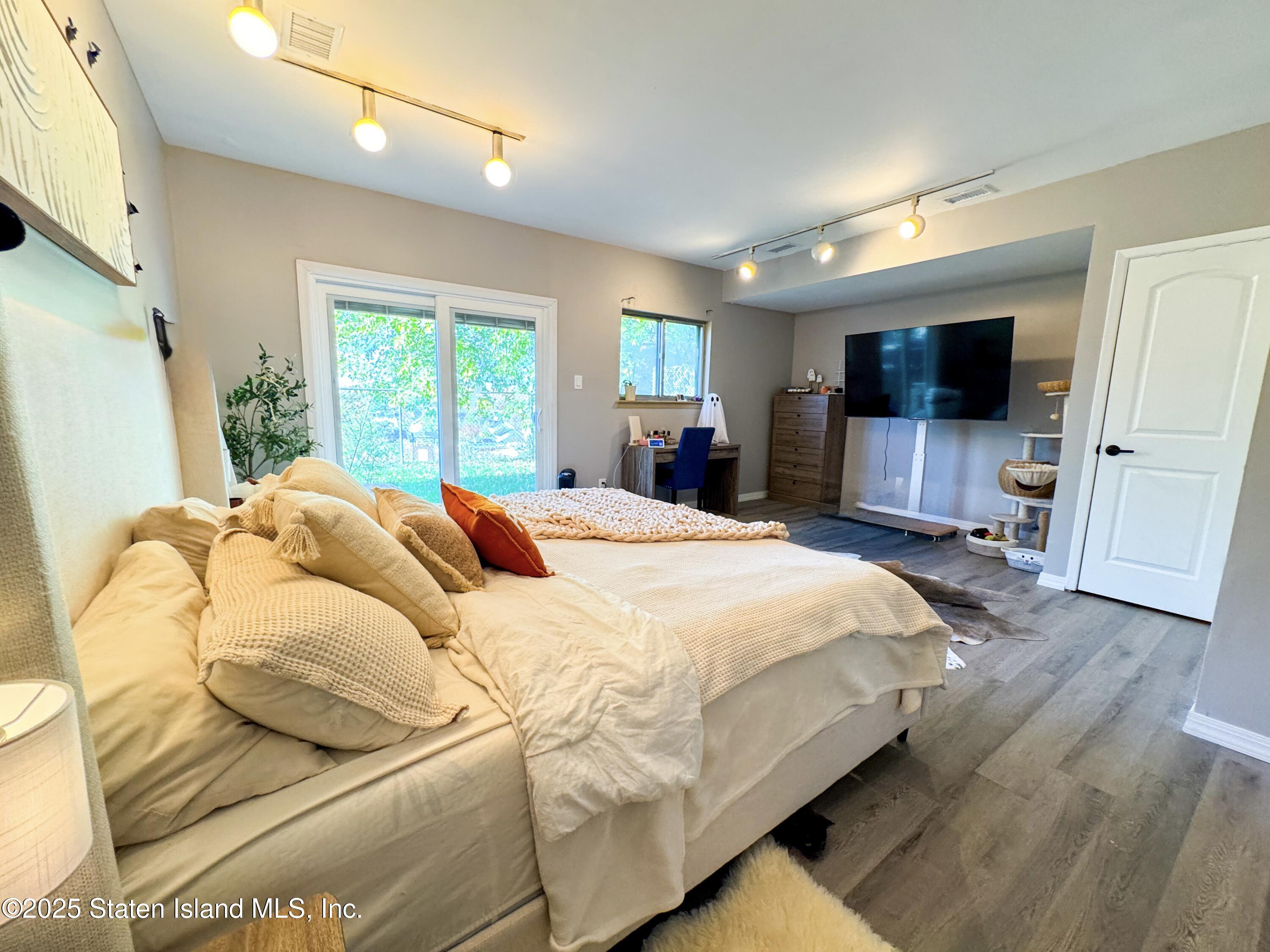 280 Rolling Hill Green Staten Island, NY 10312 - Photo 16 of 22 a bedroom with a bed window and a flat screen tv