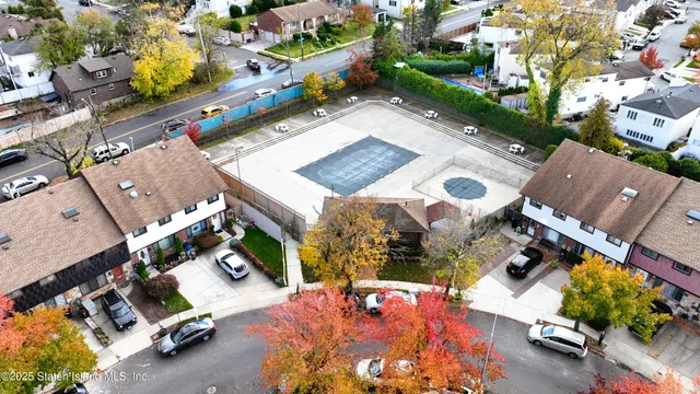 an aerial view of a house with a swimming pool and outdoor seating