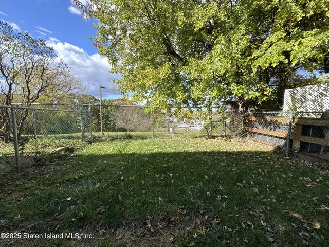 a huge green field with lots of bushes