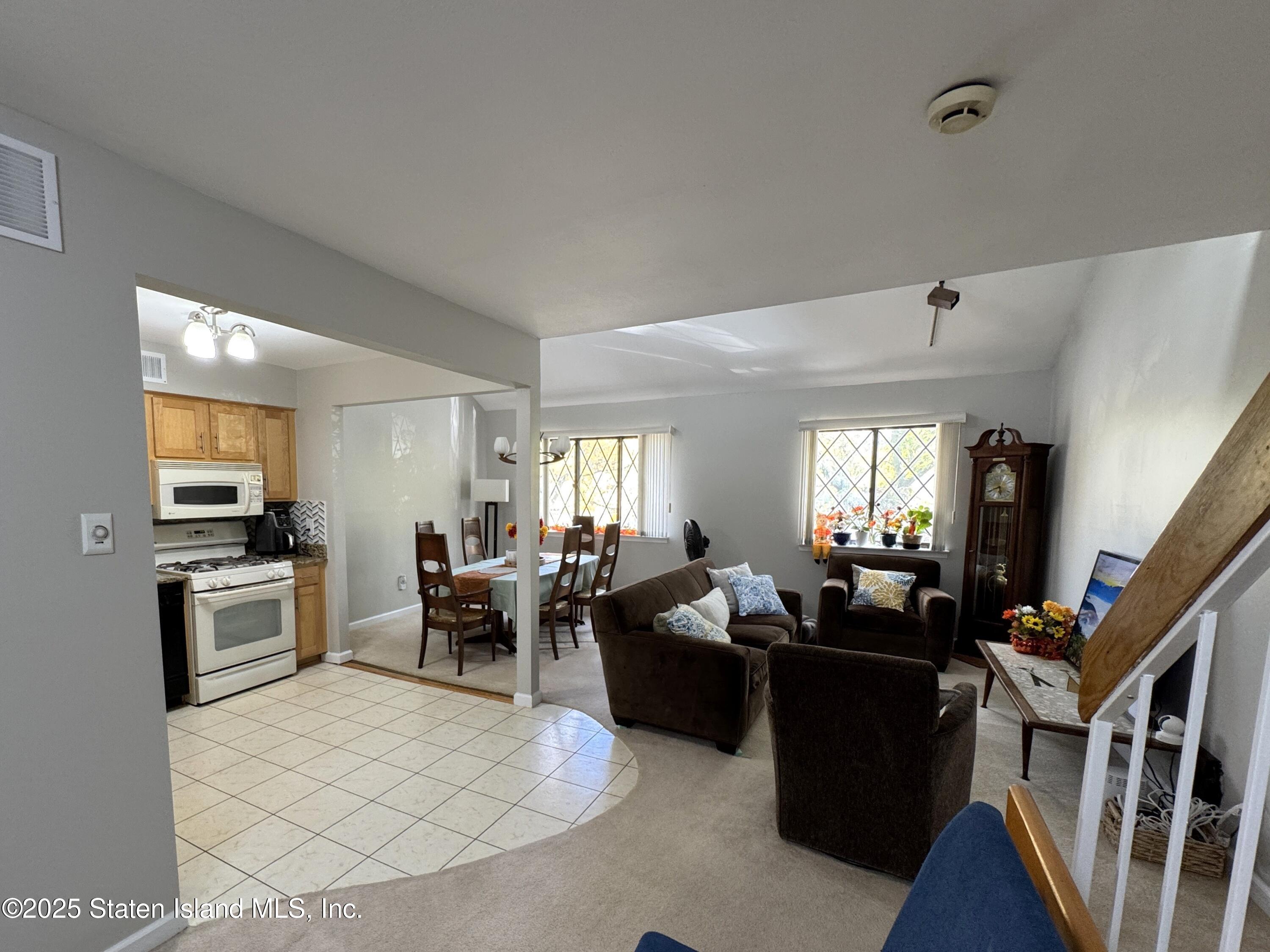 280 Rolling Hill Green Staten Island, NY 10312 - Photo 6 of 22 a living room with fireplace furniture and a flat screen tv