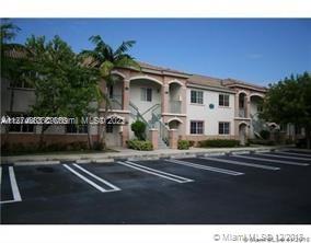 2910 Southeast 13th Road, Unit 20544 Homestead, FL 33035 - Photo 2 of 8 a front view of a house with a garden