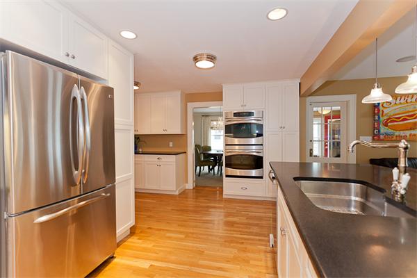 82 Cutter Hill Road Arlington, MA 02474 - Photo 6 of 14 a kitchen with stainless steel appliances granite countertop a refrigerator a stove and a sink with wooden floor