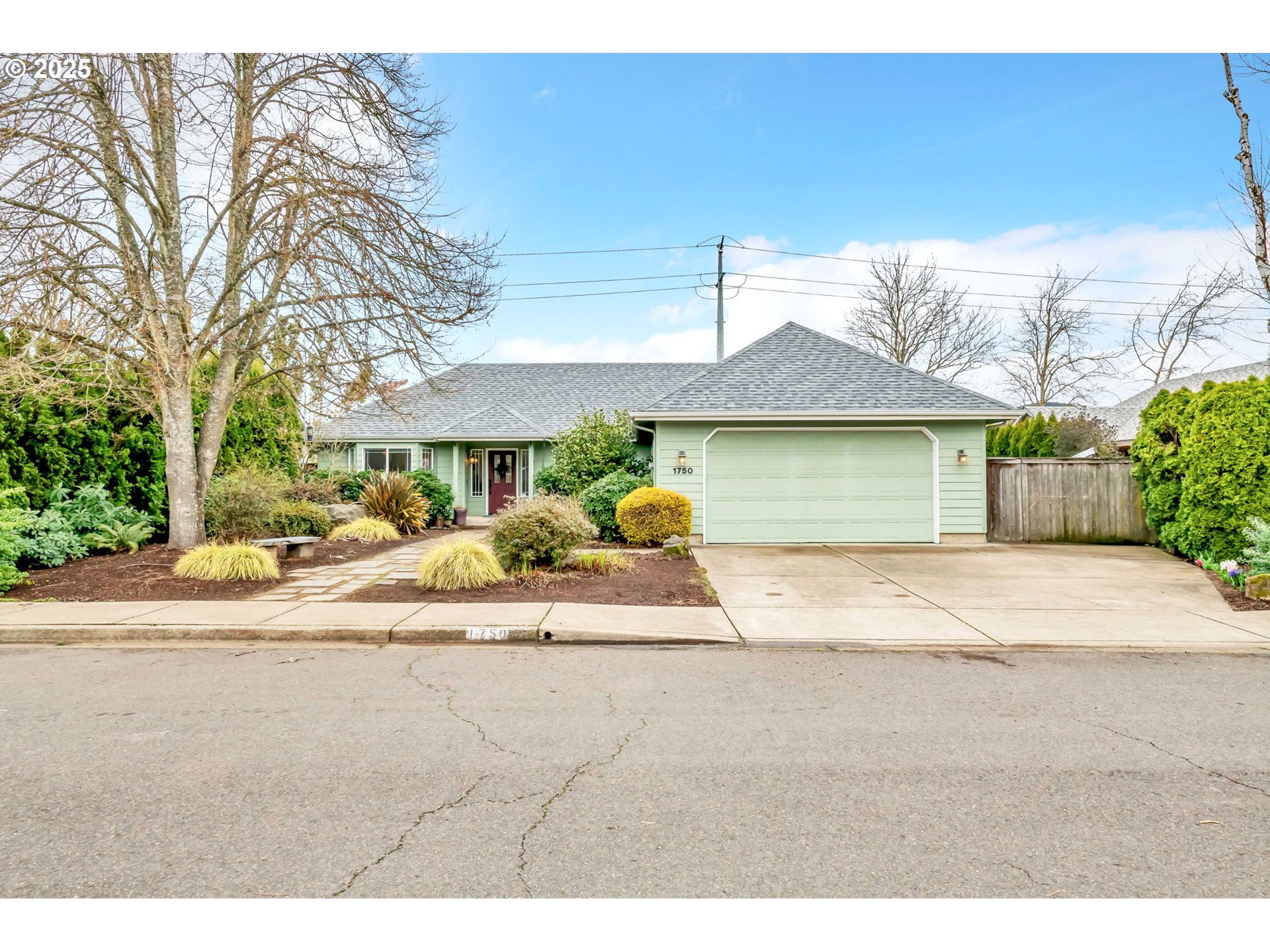 1750 Ridgley Boulevard Eugene, OR 97401 - Photo 2 of 26 a front view of a house with a yard and garage