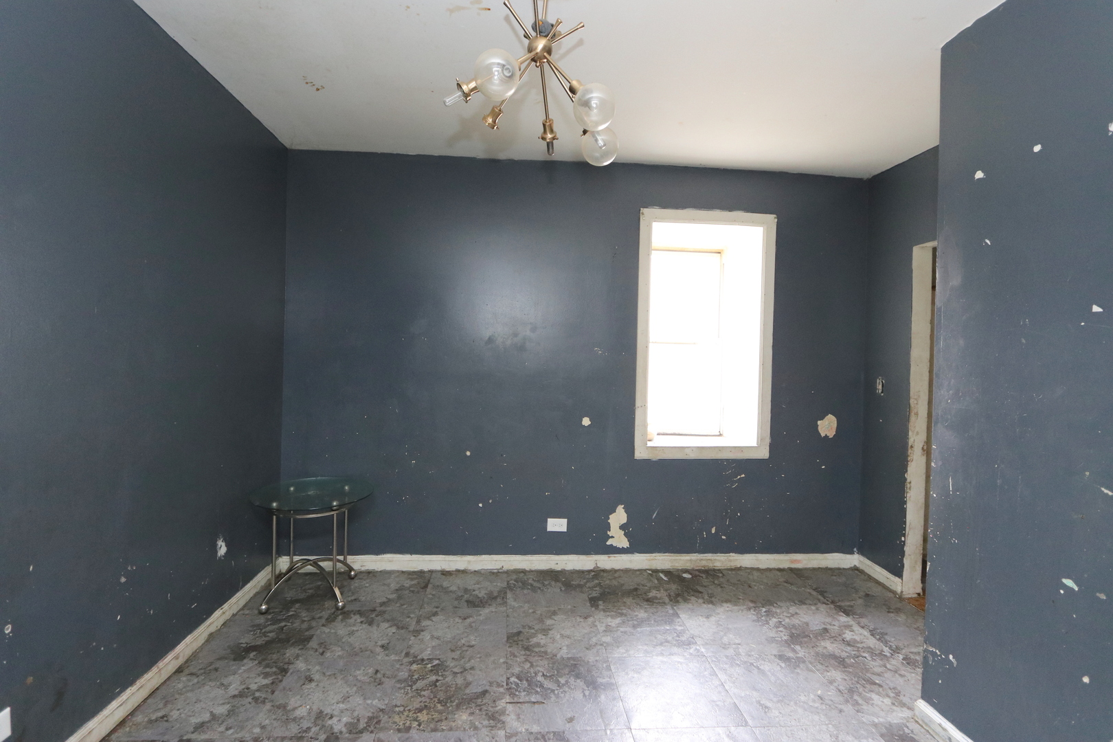 727 North Springfield Avenue Chicago, IL 60624 - Photo 13 of 22 an empty room with a window and a chandelier fan