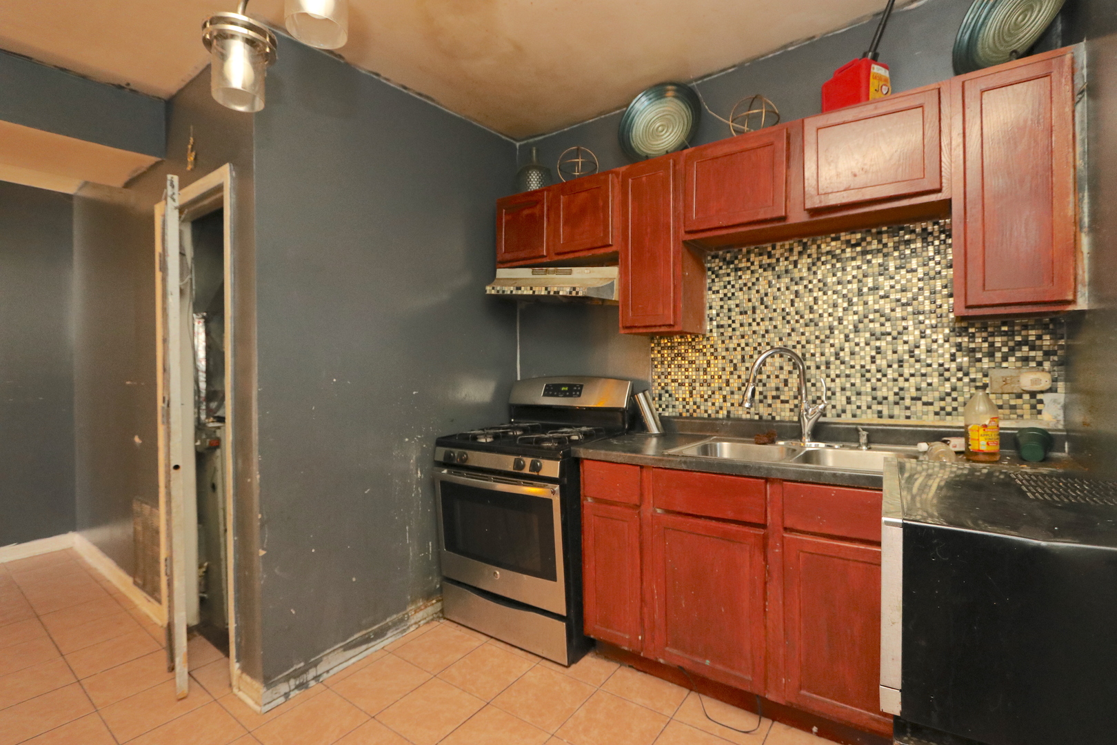 727 North Springfield Avenue Chicago, IL 60624 - Photo 4 of 22 a kitchen with stainless steel appliances granite countertop a stove a sink and a refrigerator