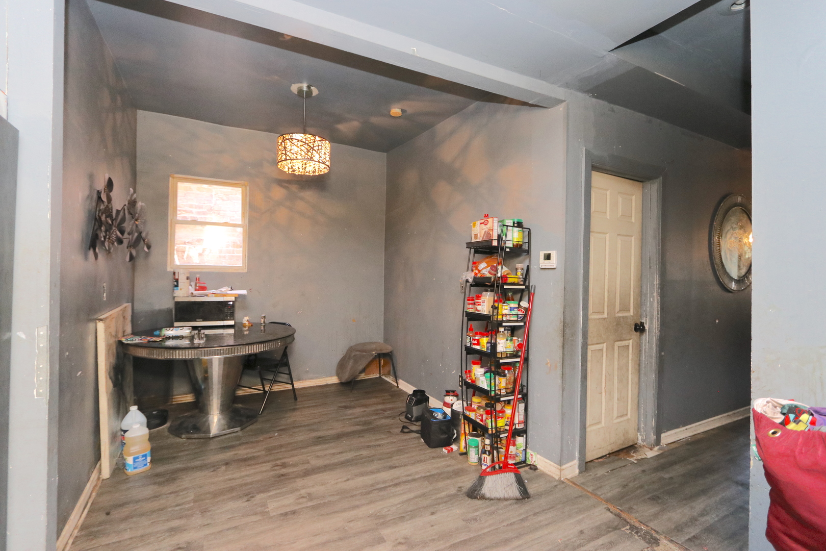 727 North Springfield Avenue Chicago, IL 60624 - Photo 5 of 22 a view of a livingroom with wooden floor a glass door and windows