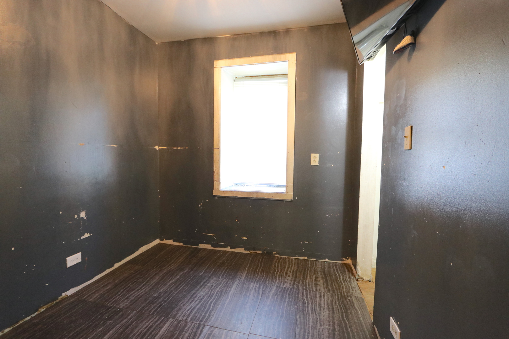 727 North Springfield Avenue Chicago, IL 60624 - Photo 6 of 22 a view of an empty room with wooden floor and a window